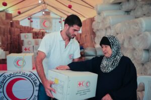 Um-Ahmad thanked the volunteers and started calling to God to protect them.